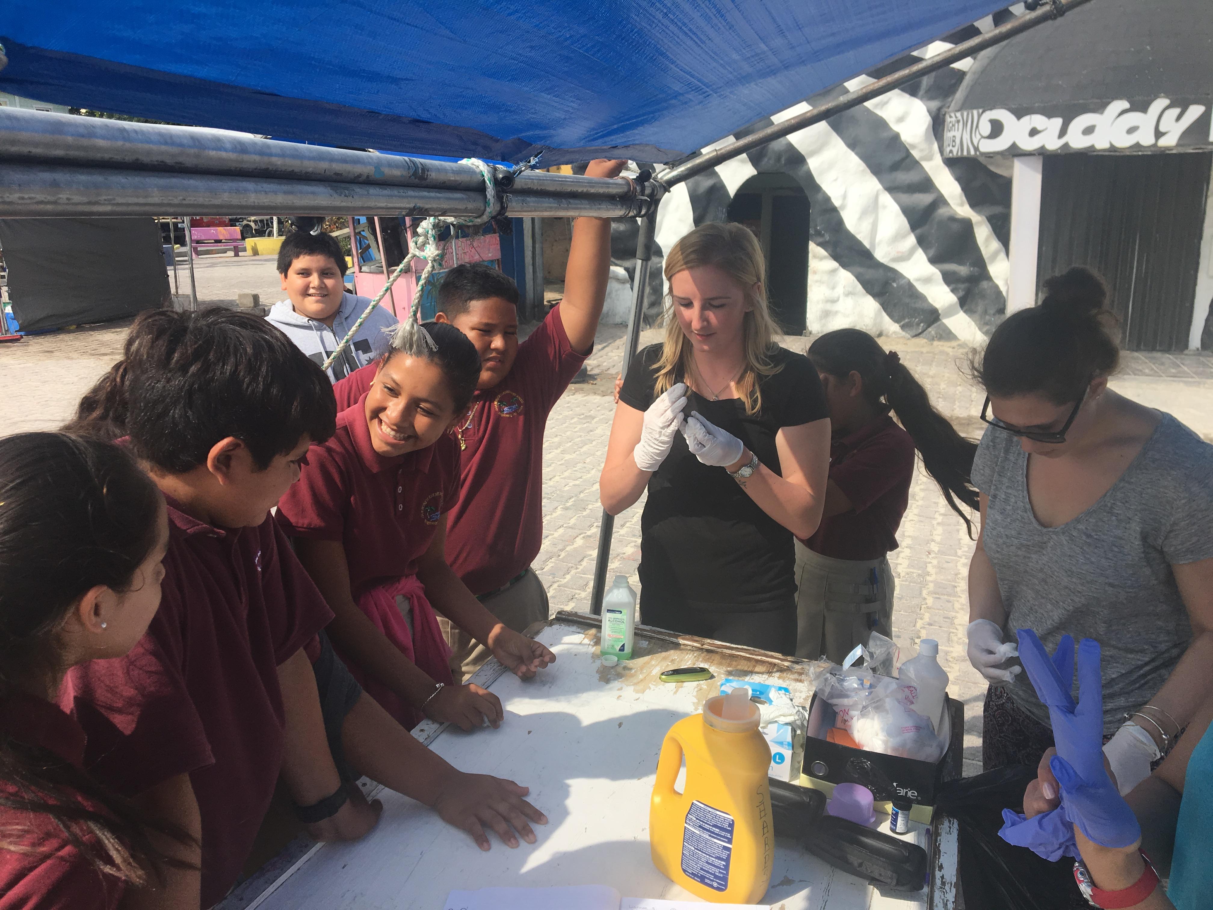 At a Public Health placement for teenagers in Belize, students chat with local children during an outreach. On the Projects Abroad Public Health internship for teenagers in Belize, students prepare for an outreach day.